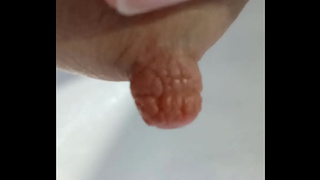 Man squeezes milk-filled breast of his eager wifey.