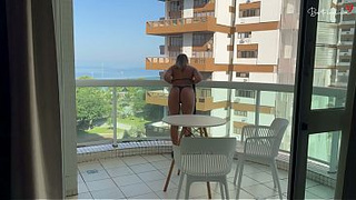 The blonde lets her towel drop and starts seducing the workers in the neighboring building.