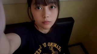 A female college student masturbate alone in a private room at a karaoke bar, using a technique she has just learned.